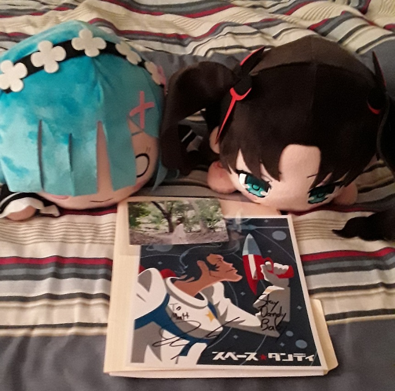 My stuff: Rem and Rin Nesoberis, the Ian Sinclair signed Dandy print (“Stay Dandy Baby”), and the Eri Sasaki signed photo. Not shown: My son’s Kyouko Nesoberi